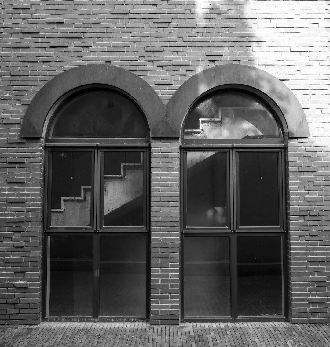 WALLPAPER⁶ — seamless rotate4 pattern from bauhaus typography, Bauhaus — base photo: Two arched windows with stairs reflected inside