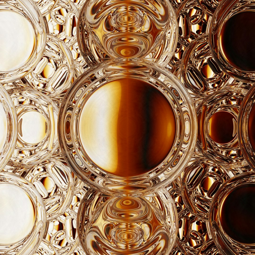 A seamless repeat pattern of golden stained glass in a rotating pinwheel symmetry, showing intricate leaded lines and honey-colored textures. — base photo: A high-resolution close-up by Rick Rothenberg capturing the intricate textures and deep gold tones o