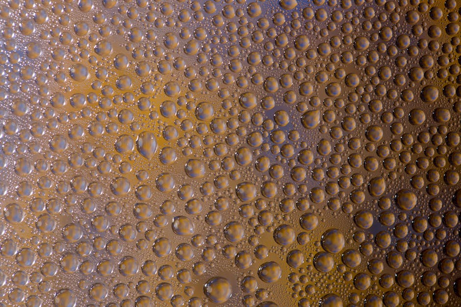 Seamless mirror wallpaper pattern — Biochemistry by wallpaper⁶ — base photo: Close-up of water droplets forming patterns on an orange surface.