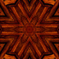 Ornate Stained Glass pattern with kaleidoscope symmetry, featuring a wooden sunburst design on a dark background in vibrant jewel tones.