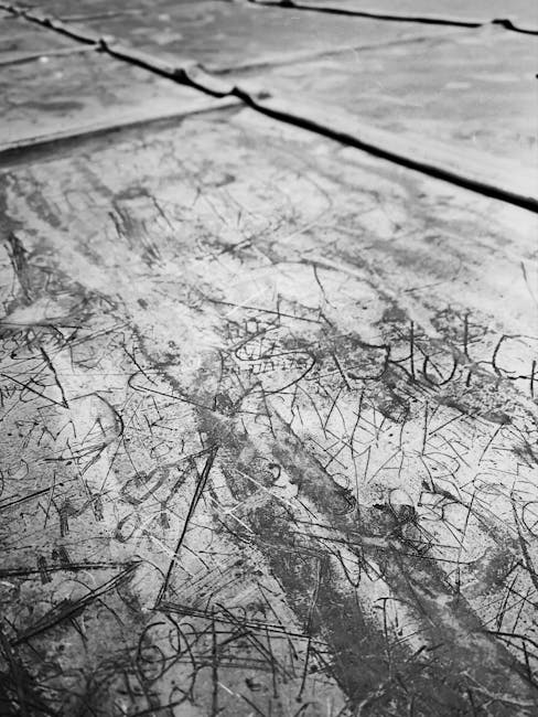Seamless kaleidoscope wallpaper pattern — Calligraphy by wallpaper⁶ — base photo: Detailed view of a scratched surface displaying a textured abstract pattern in black and white.