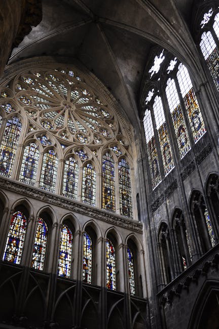 Kaleidoscope pattern of vibrant geometric shapes and colors, reminiscent of light through a cathedral stained glass window. — base photo: A close-up view capturing the rich colors and intricate leaded lines of a Gothic stained glass windo