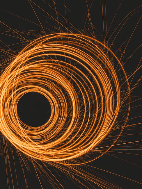 Seamless mirror wallpaper pattern — Geometry by wallpaper⁶ — base photo: Explore the captivating motion of orange light trails captured in a mesmerizing spiral pattern.