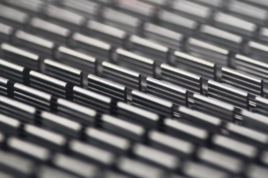 Data Vertical Strip wallpaper pattern — base photo: Close-up abstract photo of a metallic patterned surface with selective focus.