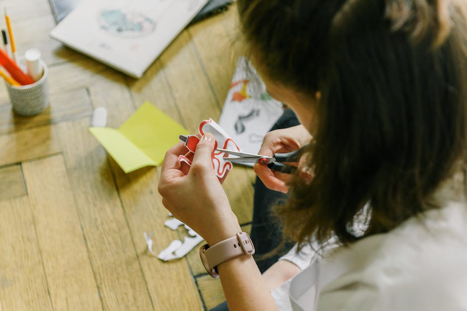 Origami Reflections pattern with Mirror symmetry, inspired by Kirigami paper art, in a self-adhesive wallpaper format. — base photo: A creative woman is engrossed in crafting, deftly using scissors to cut intricate designs from paper