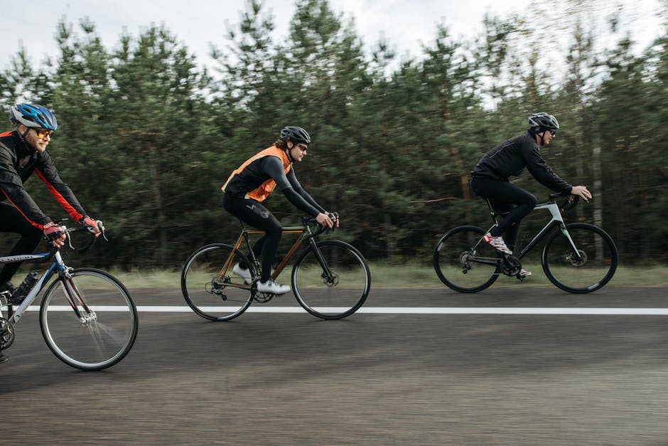 Seamless kaleidoscope wallpaper pattern — Biochemistry by wallpaper⁶ — base photo: Three cyclists wearing helmets ride on a scenic road lined with trees.