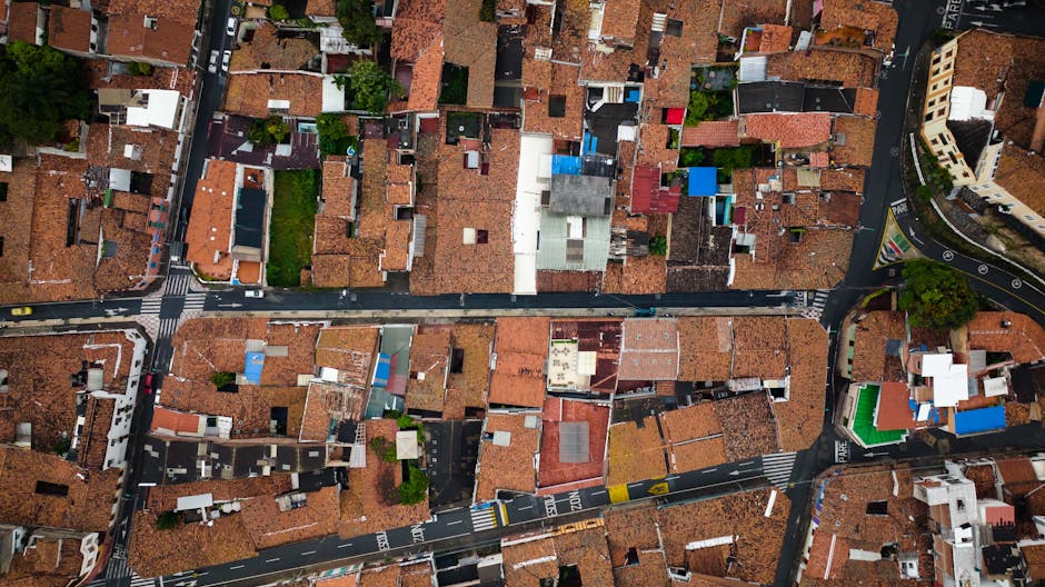 Seamless brick wallpaper pattern — Cartography by wallpaper⁶ — base photo: Aerial photograph showing red-tiled rooftops and winding streets of a town.
