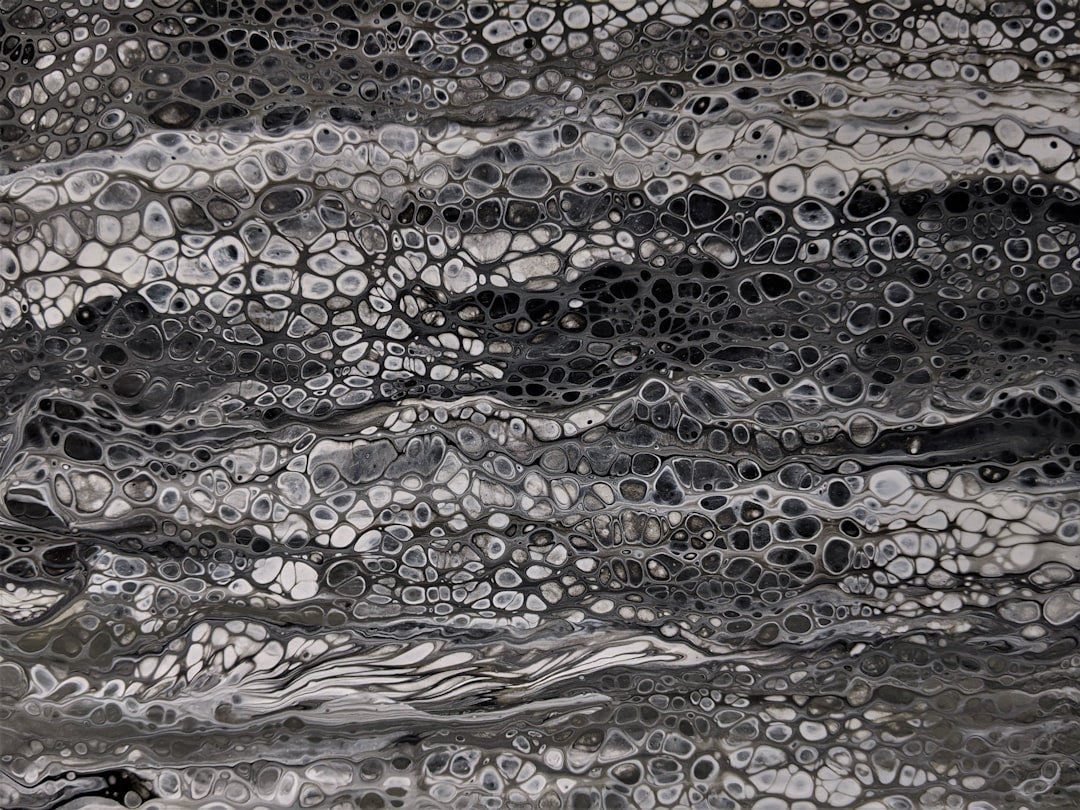 Abstract Rothko-esque pattern of swirling black and white acrylic pour, resembling water bubbles, in a rotational repeat. — base photo: A high-contrast, black and white photograph capturing the delicate, ephemeral beauty of water bubble