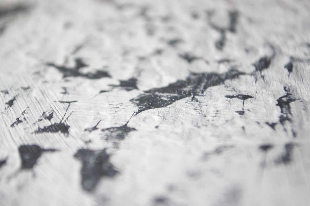 Seamless kaleidoscope wallpaper pattern — Calligraphy by wallpaper⁶ — base photo: Dark silver paint stains on white textured background, focused angled view