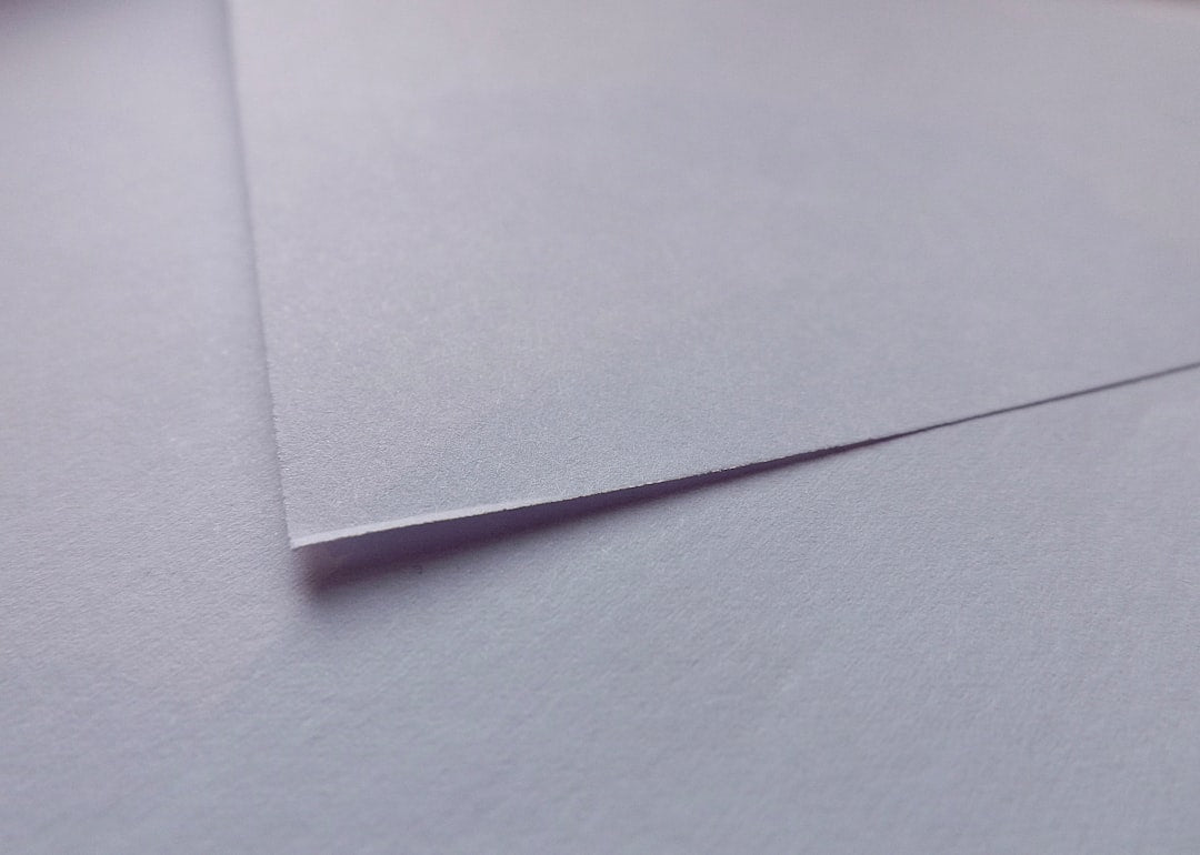Intricate origami folds with mirror symmetry on wallpaper, showcasing wet folding paper techniques. — base photo: A close-up capture of intricately folded paper, showcasing the subtle textures and sharp creases ach