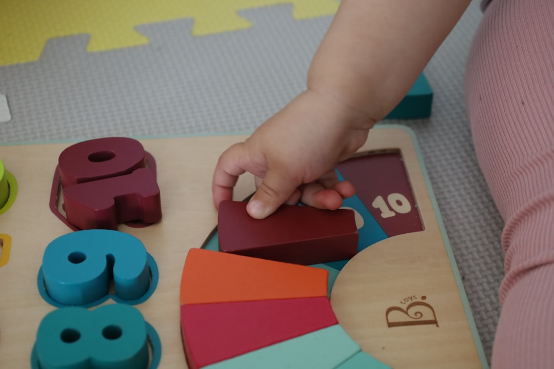 Seamless kaleidoscope wallpaper pattern — Arithmetic by wallpaper⁶ — base photo: a child is playing with wooden toys on the floor