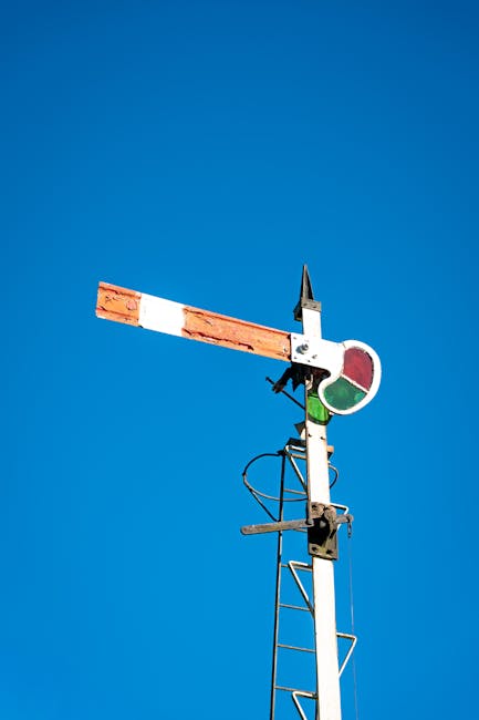 Seamless kaleidoscope wallpaper pattern — Biochemistry by wallpaper⁶ — base photo: Vintage railway signal, Sri Lanka, set against a clear blue sky, symbolizing travel and nostalgia.