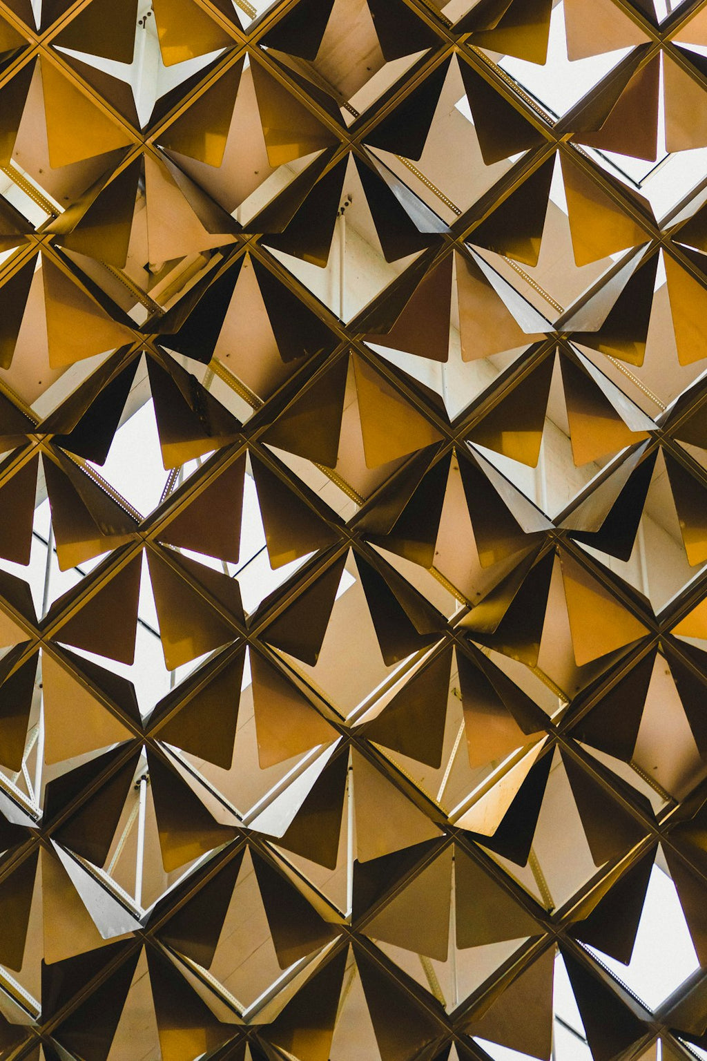 A seamless pattern of yellow and black origami squares arranged symmetrically, featuring mirror symmetry, ideal for wallpaper. — base photo: A close-up view of folded paper squares in alternating yellow and black, arranged to demonstrate per