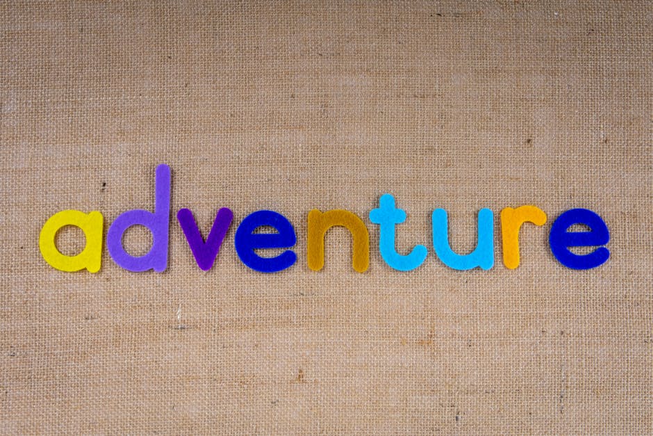 Meteorology Kaleidoscope wallpaper pattern — base photo: Colorful letters spelling 'adventure' on a textured brown burlap background.