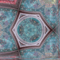 Close-up detail of stained glass window sections arranged in a repeating hexagonal pattern with dark leaded outlines.