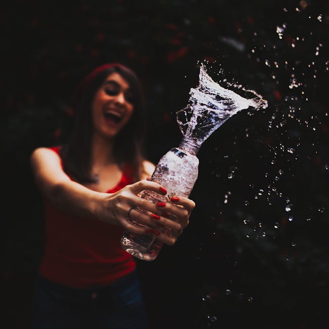 WALLPAPER⁶ — seamless kaleidoscope pattern from klein bottle, Topology — base photo: Dynamic shot of a woman squeezing a water bottle, creating an exciting splash effect.