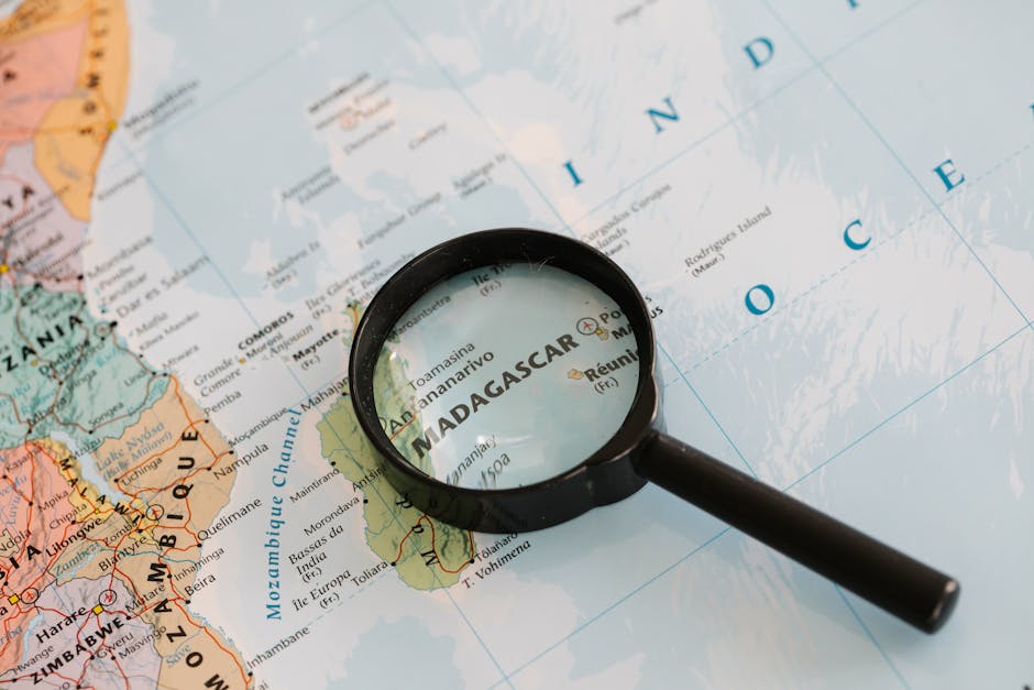 Meteorology Kaleidoscope wallpaper pattern — base photo: Close-up of Madagascar on a map with a magnifying glass highlighting the area.