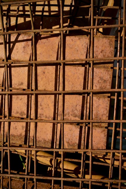 Seamless kaleidoscope wallpaper pattern — Calligraphy by wallpaper⁶ — base photo: Close-up of a rusty metal cage creating geometric patterns with earthy tones.