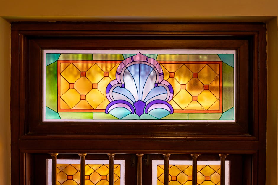 Colorful geometric kaleidoscope pattern inspired by Islamic stained glass, featuring vibrant reds, blues, and greens. Seamless repeat design. — base photo: A close-up view of a colorful stained glass window in Colombo, Sri Lanka. The intricate Islamic-insp