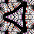 A close-up of intricate hexagonal stained glass patterns in vibrant colors, captured from a low angle.