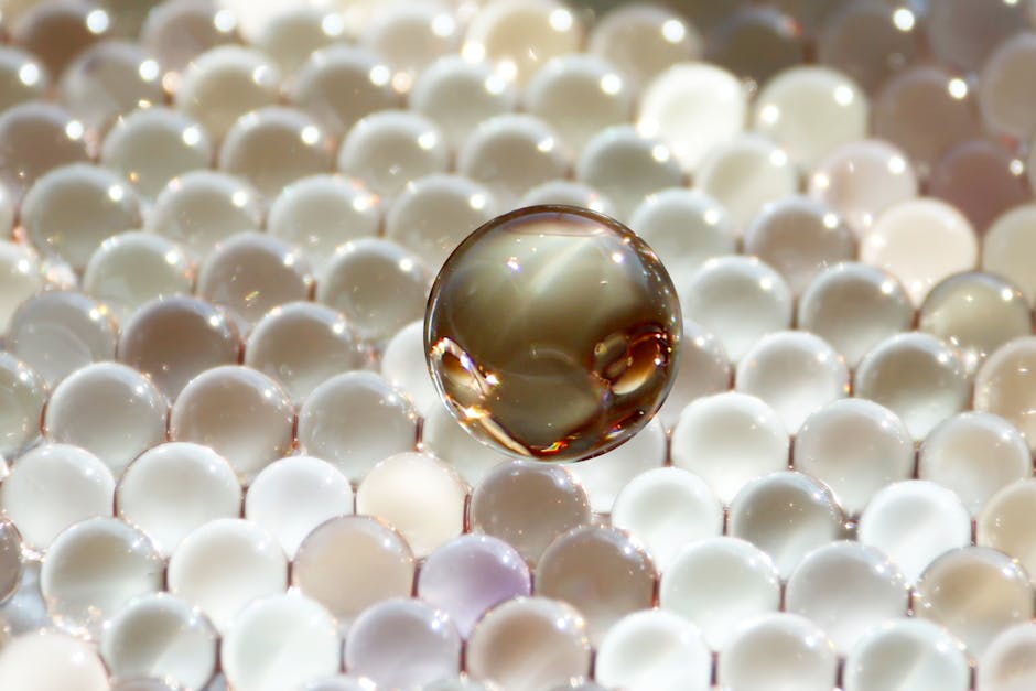 Physics Wave wallpaper pattern — base photo: Abstract composition of reflective glass spheres in various textures creating a glowing ambiance.