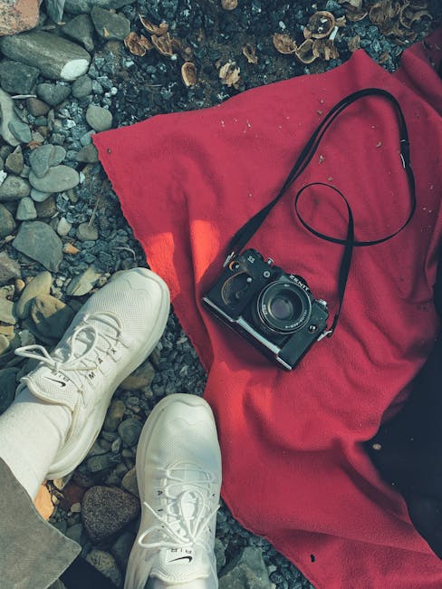 Cryptography Kaleidoscope wallpaper pattern — base photo: A vintage camera on a red blanket with sneakers on pebbles highlights a casual outdoor moment.