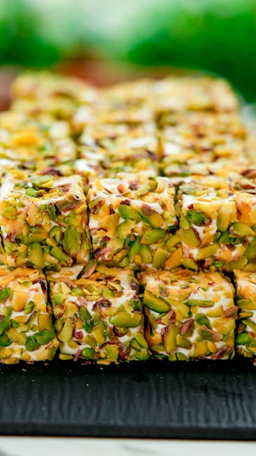 Seamless mirror wallpaper pattern — Geometry by wallpaper⁶ — base photo: Stacked pistachio nougat cubes with vibrant nuts, offering a visually appetizing treat.