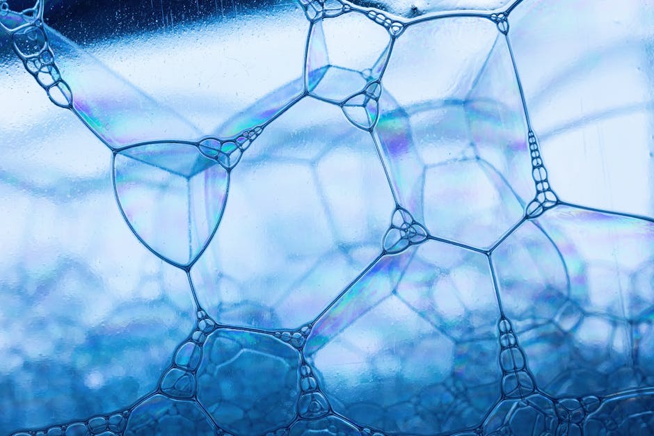 Chemistry Brick wallpaper pattern — base photo: Close-up view of soap bubbles with a reflective blue hue, showcasing geometric patterns.
