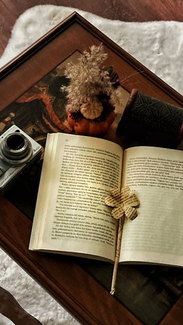 Seamless mirror wallpaper pattern — Origami by wallpaper⁶ — base photo: Warm autumn still life featuring an open book, vintage camera, and decorative elements.