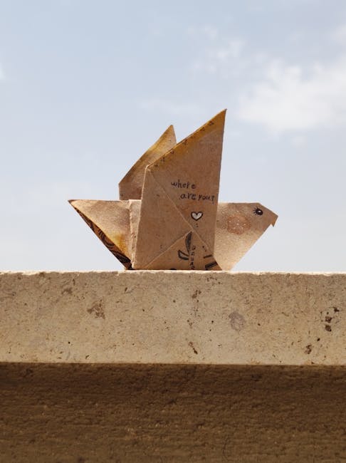 Seamless mirror wallpaper pattern — Origami by wallpaper⁶ — base photo: An origami bird with 'where are you?' text sits on a stone ledge under a bright sky.