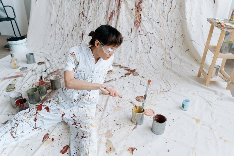 Abstract Diamond wallpaper pattern — base photo: A young artist in paint-splattered overalls works on a vibrant abstract piece in their studio.