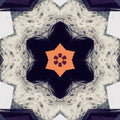 A radial kaleidoscopic pattern created from a human portrait, featuring warm skin tones and symmetrical geometric shapes.