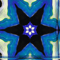 Blue and white abstract marble swirls arranged in a symmetrical kaleidoscope pattern on wallpaper.