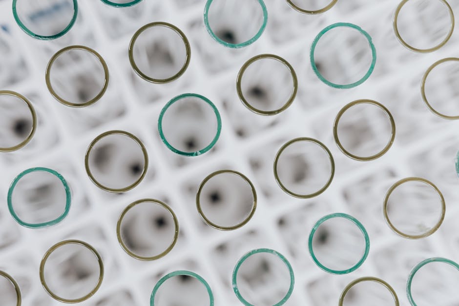 Molecular formulas arranged in a brick pattern, featuring classic chemistry elements and laboratory aesthetic. — base photo: A meticulously arranged top-down view inside a laboratory glass tube. The scene features diverse, co