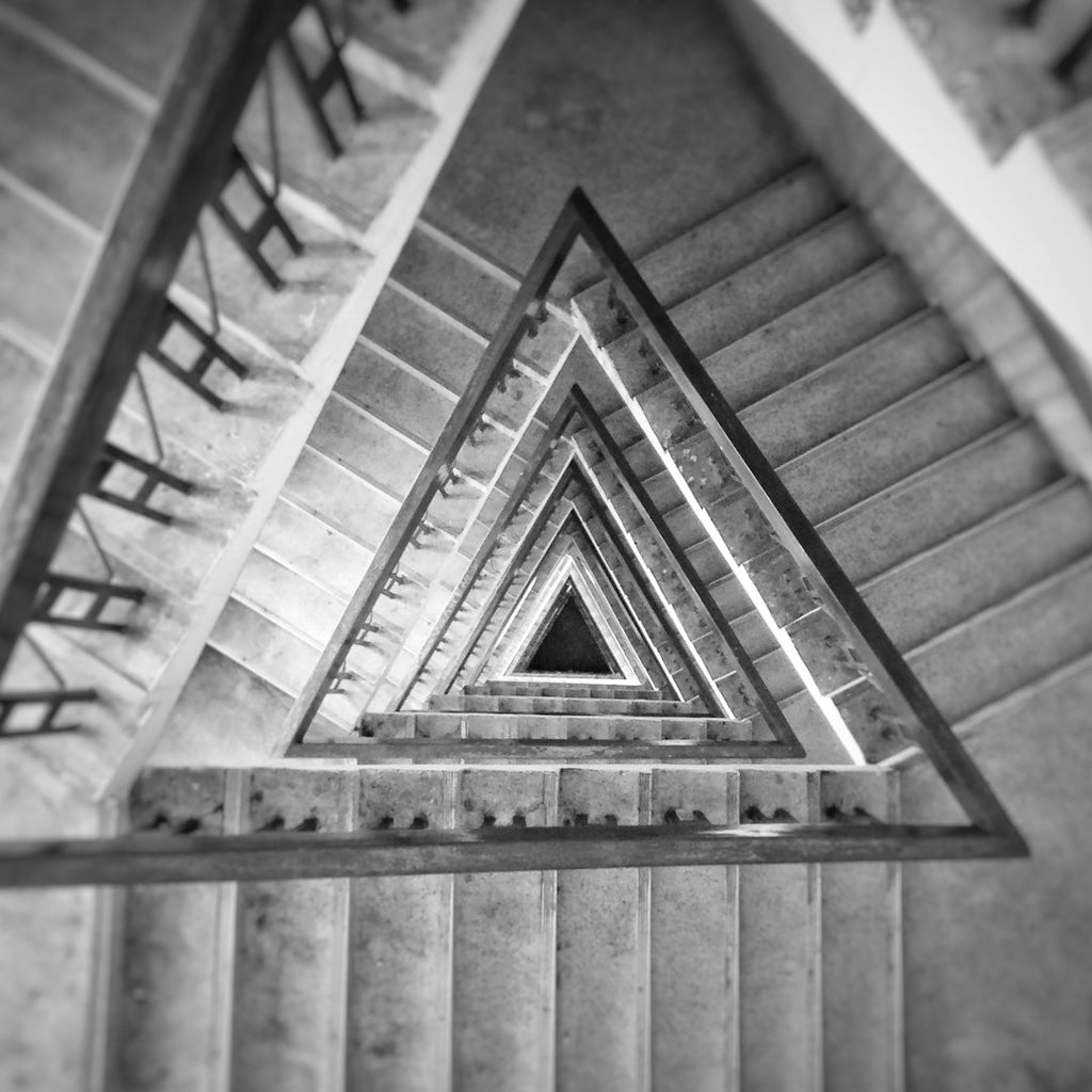 A monochromatic Op-Art pattern with complex Kaleidoscope symmetry featuring black and white geometric shapes and sharp lines. — base photo: A stark black-and-white optical art composition featuring distorted linear grids and sharp triangula