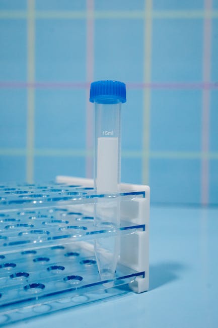 Seamless hex wallpaper pattern — Biochemistry by wallpaper⁶ — base photo: A single blue-capped plastic test tube displayed vertically in a test tube rack, laboratory scene.