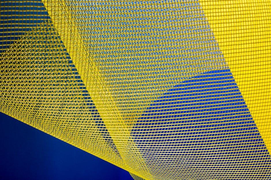 Topology Pinwheel wallpaper pattern — base photo: Dynamic abstract image featuring yellow mesh patterns against a deep blue background, creating an ar