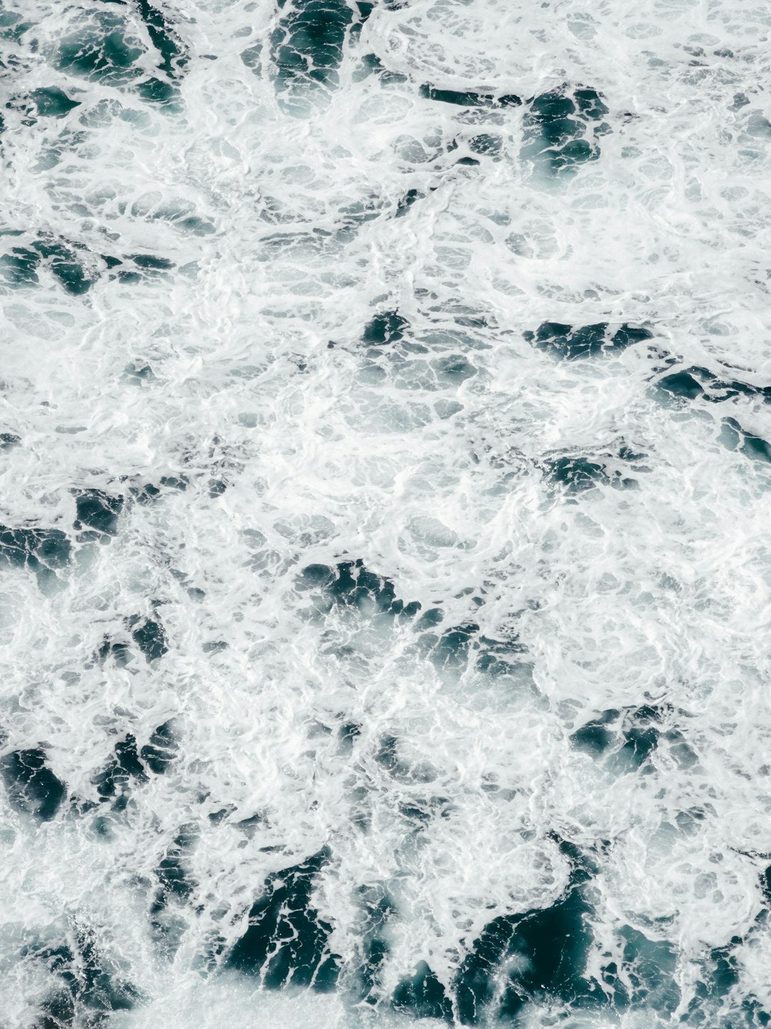 Oceanography Horizontal Strip wallpaper pattern — base photo: A man riding a surfboard on top of a wave