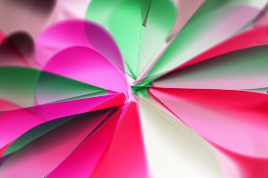 Seamless kaleidoscope wallpaper pattern — Origami by wallpaper⁶ — base photo: A dynamic abstract pattern featuring vivid colored paper layers in pink, green, and white.