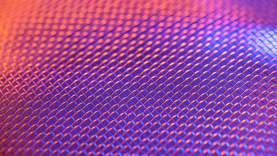 Seamless mirror wallpaper pattern — Biochemistry by wallpaper⁶ — base photo: Close-up of a metallic mesh pattern with vibrant lighting creating a colorful abstract effect.
