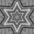 A monochromatic Op-Art pattern with complex Kaleidoscope symmetry featuring black and white geometric shapes and sharp lines.