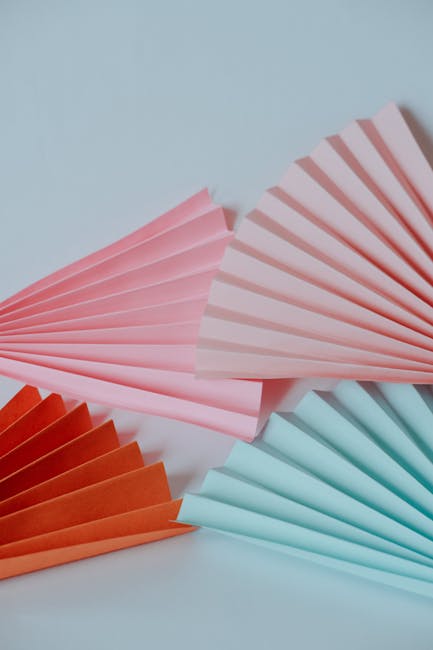 Seamless kaleidoscope wallpaper pattern — Origami by wallpaper⁶ — base photo: Brightly colored folded paper fans in a minimalist setting create a vibrant abstract composition.