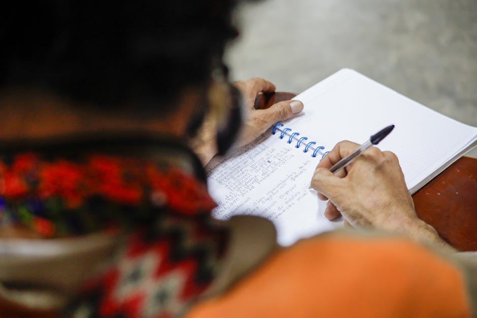 Seamless mirror wallpaper pattern — Calligraphy by wallpaper⁶ — base photo: Close-up of a person writing in a spiral notebook with a ballpoint pen.