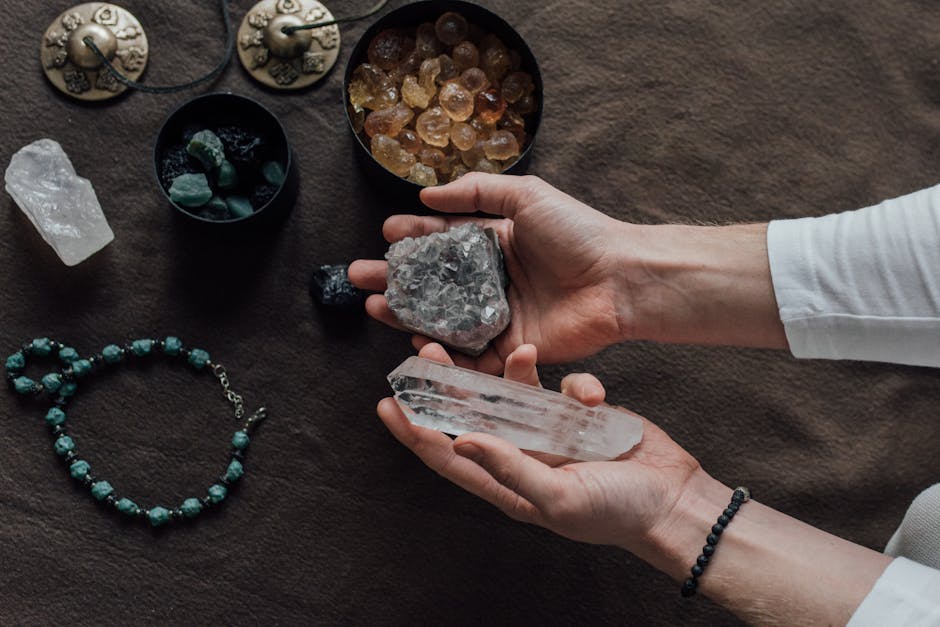 Mineralogy Kaleidoscope wallpaper pattern — base photo: Close-up of hands holding healing crystals, surrounded by natural gemstones and a beaded bracelet.