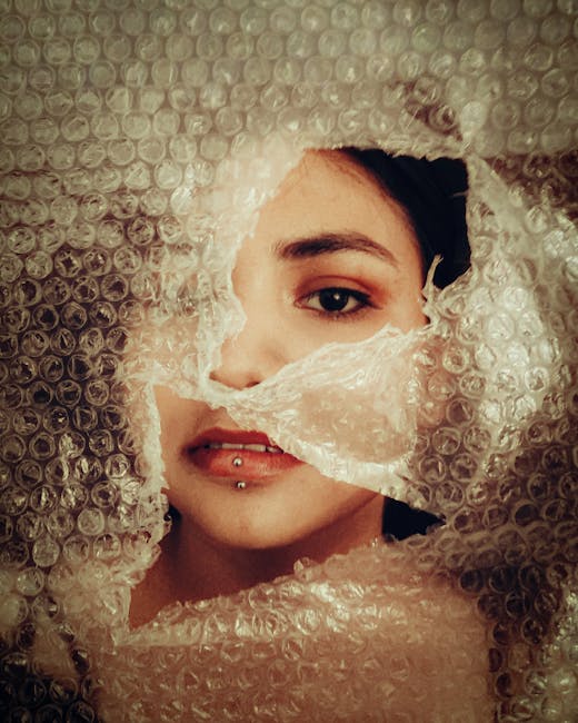 Portraits Hexagon wallpaper pattern — base photo: Artistic portrait of a woman peering through bubble wrap, creating a moody and textured look.