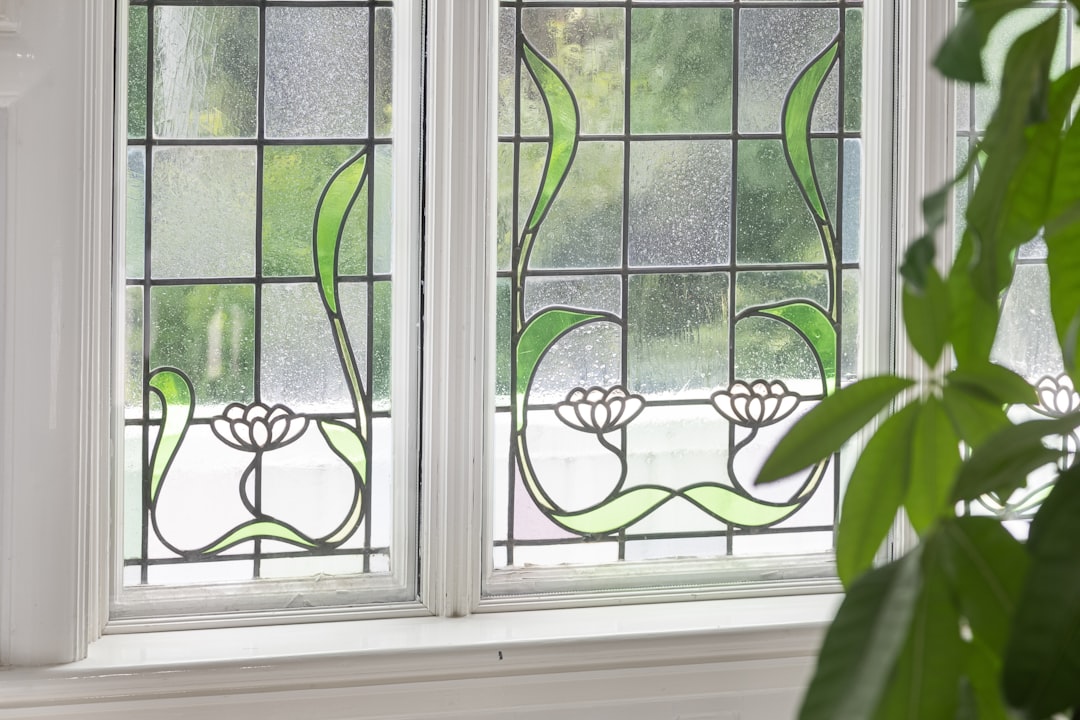 A close-up of a repeating kaleidoscope pattern inspired by leaded stained glass details, with intricate lines and vibrant colors visible. — base photo: A close-up view of a traditional leaded glass window, showcasing the intricate network of lead came 