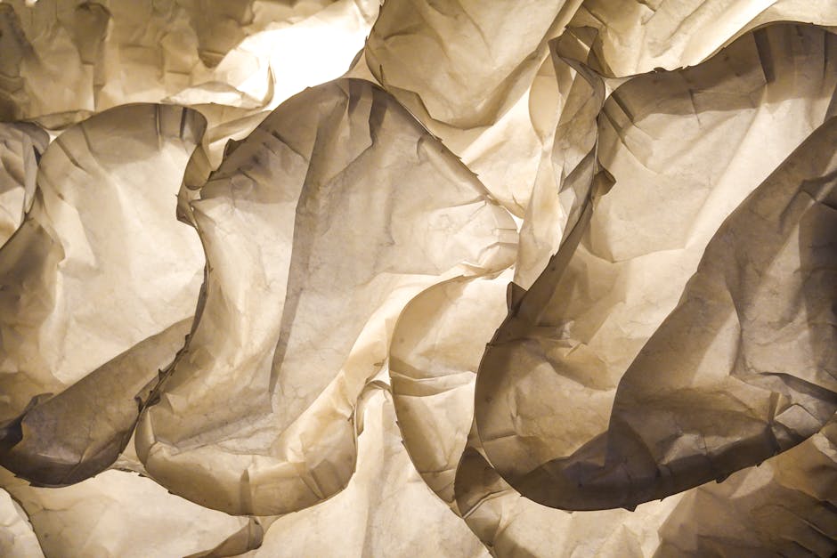 Seamless mirror wallpaper pattern — Origami by wallpaper⁶ — base photo: Explore the intricate beauty of crumpled paper illuminated by soft light, showcasing texture and dep