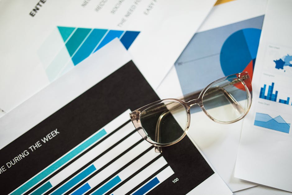 Statistics Mirror wallpaper pattern — base photo: Close-up of eyeglasses resting on financial documents with various charts and graphs.