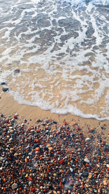 Oceanography Wave wallpaper pattern — base photo: Waves gently wash over a rocky beach, creating intricate sea foam patterns.