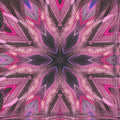 An intricate kaleidoscope pattern of amber and black shards forming a glowing, radial geometric symmetry.